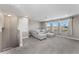 A spacious upper-level living room includes plush carpeting, recessed lighting, and plenty of natural light at 11325 78Th E St, Parrish, FL 34219