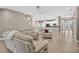 A modern living room features an open floor plan and a kitchen, perfect for gatherings and entertaining at 11325 78Th E St, Parrish, FL 34219