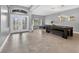 Spacious living room featuring tile flooring, a modern light fixture, and pool table at 11325 78Th E St, Parrish, FL 34219