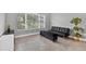 Living room with tile floors, a window, and a black futon at 11325 78Th E St, Parrish, FL 34219