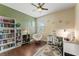 A sunlit home office with hardwood floors, a bookshelf, and a comfortable papasan chair at 11325 78Th E St, Parrish, FL 34219