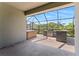Screened-in patio features an outdoor kitchen with a grill and hot tub at 11325 78Th E St, Parrish, FL 34219