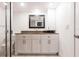 Bright bathroom with white cabinets, granite countertop, modern fixtures, and decorative accents creating a clean space at 1150 Tarpon Center Dr # 1D, Venice, FL 34285