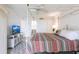 This charming bedroom features a four-poster bed, TV, and calming beach view displayed on the screen at 1150 Tarpon Center Dr # 1D, Venice, FL 34285