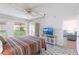 Comfortable bedroom with canopy bed, ceiling fan and views of green space at 1150 Tarpon Center Dr # 1D, Venice, FL 34285