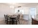 Open dining room with hardwood floors, decorative lighting and bar access to the kitchen at 1150 Tarpon Center Dr # 1D, Venice, FL 34285
