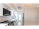 Updated kitchen with white cabinets, stainless steel appliances, and modern finishes at 1150 Tarpon Center Dr # 1D, Venice, FL 34285