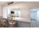 Bright modern kitchen with white cabinets, stainless appliances and a view of the entry door at 1150 Tarpon Center Dr # 1D, Venice, FL 34285