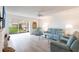 Cozy living room with hardwood floors, fan, decorative fireplace, and glass doors with outdoor views at 1150 Tarpon Center Dr # 1D, Venice, FL 34285