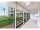 Enclosed porch offering views of the building and surrounding landscaped yard at 1150 Tarpon Center Dr # 1D, Venice, FL 34285
