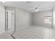 Spacious bedroom with tile flooring, ceiling fan, and access to bathroom and closet at 11835 Shrewsbury Ln, Parrish, FL 34219
