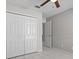 Tile bedroom with a double door closet and neutral walls with an open entry way at 11835 Shrewsbury Ln, Parrish, FL 34219