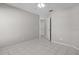 Tile bedroom with neutral walls featuring ceiling fan and entry doorway at 11835 Shrewsbury Ln, Parrish, FL 34219