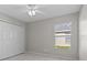Bedroom with a double door closet and view of the exterior yard from a window at 11835 Shrewsbury Ln, Parrish, FL 34219