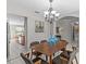 Dining room with gray walls, tile floors, and a chandelier lighting the wood table at 11835 Shrewsbury Ln, Parrish, FL 34219