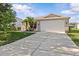 Charming single-story home featuring a well-maintained lawn, mature landscaping, and a two-car garage at 11835 Shrewsbury Ln, Parrish, FL 34219