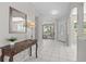 Bright foyer featuring tile flooring, a decorative mirror, and a charming wood console table at 11835 Shrewsbury Ln, Parrish, FL 34219