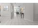 Bright hallway with tile flooring, neutral paint, and an open layout leading to the living areas at 11835 Shrewsbury Ln, Parrish, FL 34219
