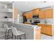 Kitchen featuring wooden cabinets, a breakfast bar with seating, and modern appliances at 11835 Shrewsbury Ln, Parrish, FL 34219