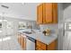 Bright kitchen featuring wood cabinets, white countertops, and stainless steel dishwasher at 11835 Shrewsbury Ln, Parrish, FL 34219