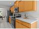 Cozy kitchen with wood cabinets, stainless steel appliances, and ample counter space at 11835 Shrewsbury Ln, Parrish, FL 34219