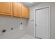 Laundry room with upper cabinets and a white entry door at 11835 Shrewsbury Ln, Parrish, FL 34219