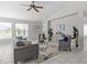Comfortable living room with neutral tones, tile floors, and views of the backyard pool at 11835 Shrewsbury Ln, Parrish, FL 34219