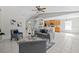 Open living room with tile flooring, modern furnishings and view into kitchen at 11835 Shrewsbury Ln, Parrish, FL 34219