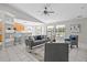 Open concept living room with modern decor, tile flooring, and abundant natural light at 11835 Shrewsbury Ln, Parrish, FL 34219