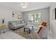 Bright living room with tile floors, stylish furniture, and large windows providing plenty of natural light at 11835 Shrewsbury Ln, Parrish, FL 34219