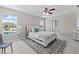 Spacious main bedroom featuring tile flooring, ceiling fan, and two windows with water view at 11835 Shrewsbury Ln, Parrish, FL 34219