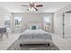 Bright main bedroom featuring tile flooring, ceiling fan, and two windows with pool view at 11835 Shrewsbury Ln, Parrish, FL 34219