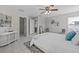 Bright main bedroom featuring tile flooring, ceiling fan, and ensuite bathroom access at 11835 Shrewsbury Ln, Parrish, FL 34219