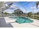 Inviting screened-in pool area with a serene waterfront view, perfect for relaxation and entertainment at 11835 Shrewsbury Ln, Parrish, FL 34219