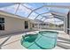 A view of the kidney shaped pool, patio, and screened-in enclosure from the deck at 11835 Shrewsbury Ln, Parrish, FL 34219