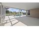 A large, covered outdoor space featuring a screened-in pool with tranquil water views at 11835 Shrewsbury Ln, Parrish, FL 34219