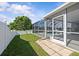 A grassy backyard with a white fence, leads to serene views of the lake beyond at 11835 Shrewsbury Ln, Parrish, FL 34219