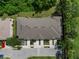 Aerial shot of a multi-unit residential building, featuring well-maintained roofs, landscaping, and parking areas at 11916 Castine St, New Port Richey, FL 34654