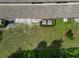 Aerial view of a well-maintained backyard with lush green grass and landscaping and two air conditioning units at 11916 Castine St, New Port Richey, FL 34654