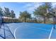 Outdoor basketball court within the community, with playground in background, offers residents a recreational space for exercise and fun at 11916 Castine St, New Port Richey, FL 34654