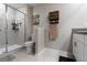 Modern bathroom featuring a glass-enclosed shower, tiled flooring, and a vanity with storage at 11916 Castine St, New Port Richey, FL 34654