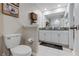 Spacious bathroom featuring dual sinks, tile flooring, and a separate enclosed shower area at 11916 Castine St, New Port Richey, FL 34654