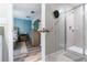 Bright bathroom featuring a modern shower with glass door and neutral-toned tile at 11916 Castine St, New Port Richey, FL 34654