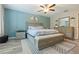 Comfortable bedroom features a queen bed, bench, and a blue accent wall at 11916 Castine St, New Port Richey, FL 34654