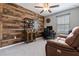 Cozy room with wood paneling, a functional desk area, and a comfortable leather sofa at 11916 Castine St, New Port Richey, FL 34654