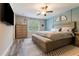 Spacious bedroom with a large bed, bench, and coordinated furniture at 11916 Castine St, New Port Richey, FL 34654