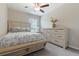 Charming bedroom featuring a decorative bed frame, comfortable bedding, and a ceiling fan at 11916 Castine St, New Port Richey, FL 34654