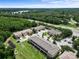Aerial view of a residential community, surrounded by lush greenery, a pond, and serene lake views at 11916 Castine St, New Port Richey, FL 34654