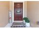 Welcoming front door with a wreath, a welcome mat, and potted plants enhancing the entrance at 11916 Castine St, New Port Richey, FL 34654
