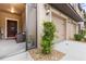 Charming entrance featuring a welcome sign, comfortable seating, and a view of the attached garage at 11916 Castine St, New Port Richey, FL 34654